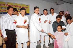 Kunal Bhadoo distributes scholarships among poor students at a function organised by the Bharat Vikas Parishad in Fatehabad