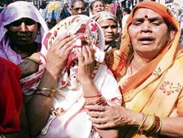 Mother of Rinky is consoled by relatives in New Delhi