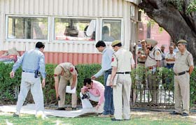 An investigation team inspects the site outside the Prime Ministers Office after a firing incident in New Delhi