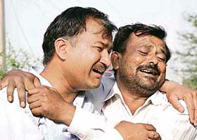 Relatives mourn for seven members of the Singla family