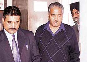 Former minister Singhi Ram (right) comes out of the district courts just before his arrest by the Vigilance in Shimla