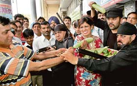 Satirist Savita Bhatti carries a basket of vegetables to be stored in a bank locker in Sector 17