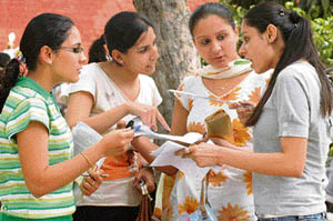 Students of a local college discuss the newly introduced OMR sheets in Ludhiana on Tuesday.