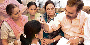 Ansar Burney, member, UN Human Rights Council advisory committee, with Sarabjit Singhs family at Bhikhiwind.
