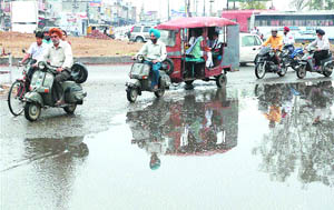 Rain that lashed the city early on Thursday morning leaves puddles on roads.
