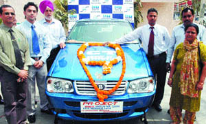 Varun Kumar Saini poses with “Blitz” — the car he made using parts from different cars lying in junkyards.