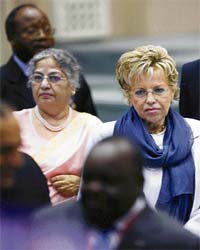 Viviane Wade, wife of Senegalese President Abdoulaye Wade (right), walks with Gursharan Kaur, wife of Prime Minister Manmohan Singh, as they arrive for a session of the first India-Africa Forum Summit in New Delhi