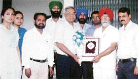Balbir Singh, principal, Shanti Tara College, and staff members felicitate Arvind Malhotra on the college premises near Ahmedgarh
