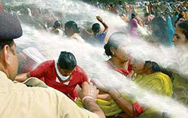 The police fires water cannons at protesting anganwadi workers in Chandigarh on Thursday.