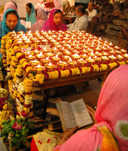 Devotees offer prayers at a local temple on Friday.