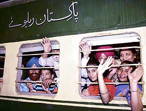 Sikh devotees, leaving for Gurdwara Panja Sahib in Pakistan for Baisakhi, wave through the Samjhauta Express windows at the Attari railway station on Friday.