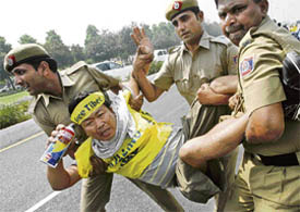 Policemen arrest a Tibetan protester in front of the Chinese embassy in New Delhi on Wednesday.