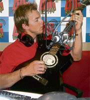 Australian cricketer Brett Lee plays guitar at a radio station in Chandigarh on Thursday.