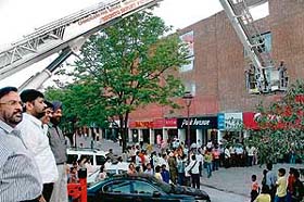 Fire and emergency services committee chairman M.P.S. Chawla and mayor Pardeep Chhabra watch a mock drill at Sector 17 market, Chandigarh