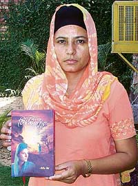 Sandeep Kaur shows the book, Bikhra Painda in Amritsar
