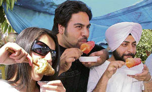 Youngster lick ice-candies in hot Ludhiana afternoon on Sunday.