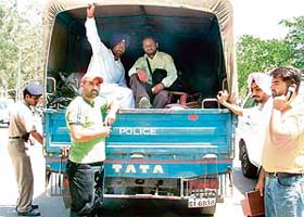 Police officials remove the belongings of unemployed PTI teachers from outside the Sector 17 office of the DPI (Secondary) in Chandigarh