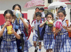 Beat the heat: Students of Asmah International School sip water to beat the heat as temperatures soared in Mohali on Wednesday.