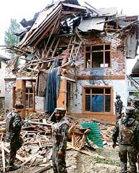 The damaged house where militants were holed up in Baramulla