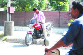 A motorcyclist tries to cross a road divider risking his life in front of DD Kendra on Mahavir Marg in Jalandhar on Thursday.