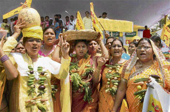 Wearing vegetable garlands, housewives in Hyderabad protest against the UPA government’s failure to curb prices of essential commodities