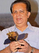 Chairman of the Indian Space Research Organisation (ISRO) G. Madhavan Nair holds a miniature replica of the Polar Satellite Launch Vehicle (PSLV) C-9 after its launch from Sriharikota, about 100 km from Chennai, on Monday.