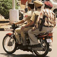 The men in khaki out for a joyride, with one of them sans a helmet,