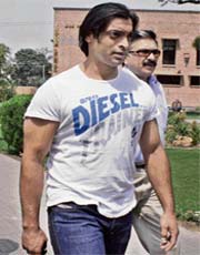 Pakistani fast bowler Shoaib Akhtar leaves after facing the tribunal at the Cricket Academy in Lahore