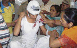 Parents attend on a student of Guru Arjun Dev Girls Senior Secondary School, Sarai Mohalla, who suffered head injuries when the roof of the school collapsed in Pathankot on Monday.