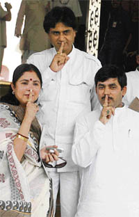 BJP leader Shahnawaz Hussain, Srichandra Kriplani and Sangeeta Kumari keep fingers on their lips to protest against Speaker Somnath Chatterjee’s action of referring cases of 32 members to the Privileges Committee, at Parliament House in New Delhi on Monday.