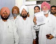 Congress leader Harminder Singh Gill (centre) with panchayat poll nominees whose papers have been declared withdrawn.