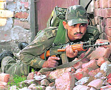 A soldier takes position during a gunfight with militants in Samba, 45 km from Jammu, on Sunday.