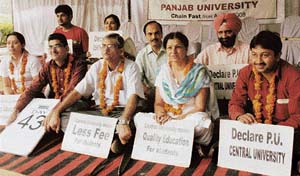 Teachers and students of anthropology department sit on the relay fast in Panjab University on Monday.