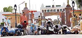 Indian fishermen kiss the soil after crossing over to India from the Attari-Wagah joint check post after their release by Pakistan
