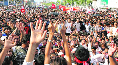 People cheer outside the Parliament House as they await a special assembly to declare Nepal a republic in Kathmandu on Wednesday.