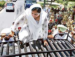 Bhattal reaches for the top: PPCC president Rajinder Kaur Bhattal climbs atop a police bus before courting arrest during a protest by Congress leaders in Chandigarh on Thursday. 