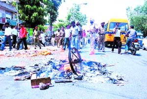 Vendors burn their rehris to protest against the anti-encroachment drive of the municipal corporation at Masand Chowk in Model Town, Jalandhar, on Thursday.