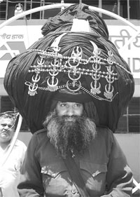 Nihang Baba Balwant Singh wearing 303-metre turban addresses a press conference in Ambala Cantonment on Friday.
