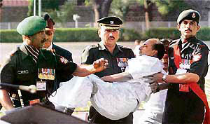 Army personnel carry defence minister A.K. Antony, who fainted during the passing-out parade ceremony, for medical treatment at the National Defence Academy in Khadakwasla in Pune on Saturday.