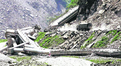 A military truck turns near collapsed section of a highway on the way to badly stricken town of Yingxiu in Wenchuan county of southwest China's Sichuan province on Tuesday.