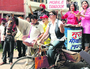 Jaspal Bhatti, president of Nonsense Club, launches "Murli Mobile Tandoor" in protest against the hike in petrol, diesel and LPG prices in Sector 19, Chandigarh, on Thursday.