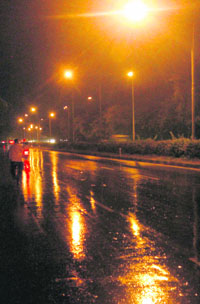 Streetlights shine in the rain-soaked streets of City Beautiful on Thursday.