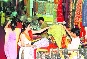 Visitors check out Awadhy cotton fabrics during an exhibition at Nehru Siddhant Kendra in Ludhiana on Wednesday.