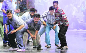Kashmir government employees brave a water cannon during a protest demanding the regularisation of their jobs and pay increases in Srinagar on Thursday.
