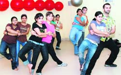 Trainees at Fitness Studio match steps with trainer Amit Verma during tango and Arabian dance latino style in Ludhiana on Monday.