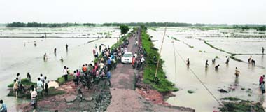 Villagers gather on a causeway to catch fish from flooded fields in Midnapore, some 150 Km south of Kolkata