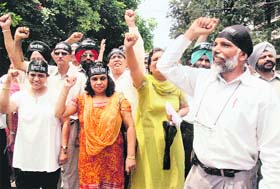 Members of joint action Committee (JAC) and PUTA protest wearing black headbands as they observe Chitawani Diwas at PU in Chandigarh