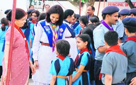 A scout trainer and school principal of Him Academy Public School interacting with the scouts on the school campus