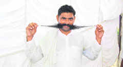 Pokar Ram of village Dharnia in Fatehabad district has become a popular figure here for his long mustache. He is seen exhibiting his long whiskers before camera.