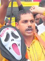 HAUNTED BY POWER CUTS: An activist of the Shiv Sena protests against massive power cuts in Amritsar on Sunday.